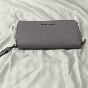 Lavender color Micheal Kors wristlet zip around wallet.